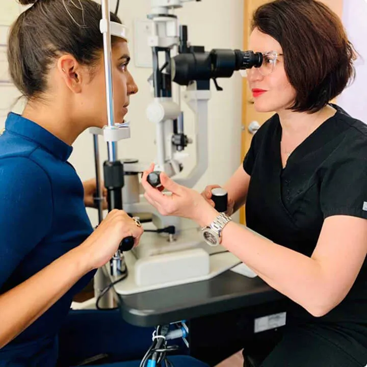 Dr. Inna Ozerov examining a patient at a slit lamp